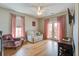 Comfortable living room with hardwood floors, white couch, pink chair, and balcony access at 4303 Misty Hollow Ln, Ravenel, SC 29470