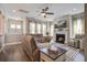 Cozy living room with a fireplace, ceiling fan, and comfortable sectional sofa at 4303 Misty Hollow Ln, Ravenel, SC 29470