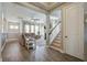 Open-concept living room with hardwood floors, stairs, and a view to the breakfast room at 4303 Misty Hollow Ln, Ravenel, SC 29470