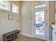 Well-lit mudroom with tiled floor, bench seating, and a door leading to the outdoors at 4303 Misty Hollow Ln, Ravenel, SC 29470