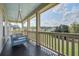 Porch with hanging bed swing providing a relaxing view of the neighborhood at 4303 Misty Hollow Ln, Ravenel, SC 29470