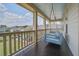 Relaxing porch with a hanging bed offering scenic views of the neighborhood at 4303 Misty Hollow Ln, Ravenel, SC 29470