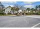 Street view of home showcasing gray siding, palm trees, a black fence, and brick pillars at 4303 Misty Hollow Ln, Ravenel, SC 29470