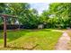 Large, grassy backyard with mature trees, shed, and full privacy fence at 4327 Bream Rd, North Charleston, SC 29418