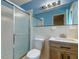 Bathroom showcasing a glass shower, toilet, vanity, and updated mirror and lighting at 4327 Bream Rd, North Charleston, SC 29418