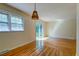 Sunlit dining room with hardwood floors, sliding glass door, and modern light fixture at 4327 Bream Rd, North Charleston, SC 29418