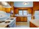 A bright kitchen with white appliances, wooden cabinets, and ample countertop space for cooking and dining at 4327 Bream Rd, North Charleston, SC 29418
