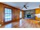 Inviting living room features wood paneled walls, hardwood floors and a charming brick fireplace at 4327 Bream Rd, North Charleston, SC 29418