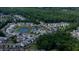 Aerial view of a community with a lake, surrounding green spaces, and numerous residential homes at 4916 Paddy Field Way, Ladson, SC 29456
