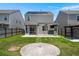 Fenced backyard featuring a patio, grassy area, and modern solar panels at 4916 Paddy Field Way, Ladson, SC 29456