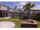 Private backyard with a firepit, palm tree, and well-maintained lawn, ideal for outdoor relaxation at 4916 Paddy Field Way, Ladson, SC 29456
