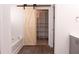 Bathroom featuring a barn door leading to a walk-in closet and a soaking tub at 4916 Paddy Field Way, Ladson, SC 29456