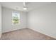 Bright bedroom featuring neutral carpet, a ceiling fan, and a large window with natural light at 4916 Paddy Field Way, Ladson, SC 29456