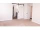 Bedroom with barn door leading to bathroom and second door leading to hall at 4916 Paddy Field Way, Ladson, SC 29456