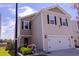 Charming two-story home with neutral siding, black shutters, and a well-maintained front yard at 4916 Paddy Field Way, Ladson, SC 29456