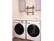 Convenient laundry room featuring modern washer and dryer units and custom shelving at 4916 Paddy Field Way, Ladson, SC 29456