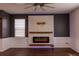 Living room featuring an electric fireplace with a white wooden facade and dark accent walls at 4916 Paddy Field Way, Ladson, SC 29456
