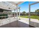 Covered screened-in porch with wood-look tile flooring overlooking the backyard at 4916 Paddy Field Way, Ladson, SC 29456