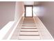 Stairway leading to the upper level, featuring white risers and wooden treads at 4916 Paddy Field Way, Ladson, SC 29456