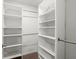 Organized walk-in closet with multiple shelves and hanging rods for ample storage at 4916 Paddy Field Way, Ladson, SC 29456