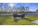 Beautiful backyard with outdoor seating, a green lawn, and views of surrounding trees at 555 Dunswell Dr, Summerville, SC 29486