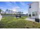 Spacious backyard with a patio area, lake view, outdoor furniture, and well-maintained grass at 555 Dunswell Dr, Summerville, SC 29486