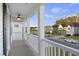 View from balcony showing neighborhood homes and manicured lawns beneath a blue sky with white railing and a ceiling fan at 555 Dunswell Dr, Summerville, SC 29486