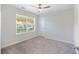 Bright bedroom featuring neutral walls, plush carpet, ceiling fan, and a window with blinds, offering a cozy retreat at 555 Dunswell Dr, Summerville, SC 29486