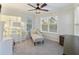 Neutral-toned bedroom with a vanity, lounge chair, and bright windows at 555 Dunswell Dr, Summerville, SC 29486