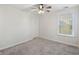 Well-lit bedroom features plush carpet, a ceiling fan, a window with blinds, and a closet for a cozy retreat at 555 Dunswell Dr, Summerville, SC 29486