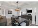Bright dining room with coffered ceiling, modern light fixture, and wood table at 555 Dunswell Dr, Summerville, SC 29486