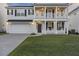 Traditional two-story home with covered porch, two-car garage, and landscaped front yard at 555 Dunswell Dr, Summerville, SC 29486