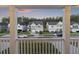 View from balcony showing neighborhood homes with manicured lawns beneath a colorful twilight sky framed by white railing at 555 Dunswell Dr, Summerville, SC 29486