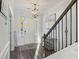 Foyer featuring a staircase with dark wood trim and an elegant chandelier at 555 Dunswell Dr, Summerville, SC 29486