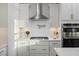 Modern kitchen featuring white cabinets, stainless steel appliances, pot filler, and ample counter space at 555 Dunswell Dr, Summerville, SC 29486