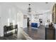 Open kitchen boasts a blue island, stainless appliances, and white cabinetry, perfect for modern living at 555 Dunswell Dr, Summerville, SC 29486