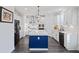 Modern kitchen with white cabinets, blue island, stainless appliances, and hardwood flooring at 555 Dunswell Dr, Summerville, SC 29486