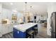 Stylish kitchen featuring a blue island, white cabinets, pendant lighting, and stainless appliances at 555 Dunswell Dr, Summerville, SC 29486