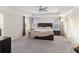This bedroom has a large bed, neutral colored walls, a ceiling fan, and carpeted floors at 555 Dunswell Dr, Summerville, SC 29486