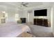 This bedroom has a large television, fire place, and neutral colored walls at 555 Dunswell Dr, Summerville, SC 29486