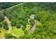 Aerial shot of a lush, wooded property with a house near a pond at 6035 Bay Pond Rd, Ravenel, SC 29470
