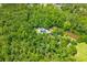 Lush forest surrounds home with solar panels near a small pond at 6035 Bay Pond Rd, Ravenel, SC 29470