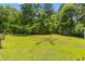 Large backyard with mature trees and landscaping at 6035 Bay Pond Rd, Ravenel, SC 29470