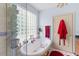 Relaxing bathroom complete with a free-standing tub and natural light from a glass block window at 6035 Bay Pond Rd, Ravenel, SC 29470