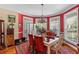 Elegant dining room with large windows and a decorative chandelier at 6035 Bay Pond Rd, Ravenel, SC 29470