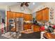 Well-lit kitchen boasting wood cabinets, stainless steel appliances, and black countertops at 6035 Bay Pond Rd, Ravenel, SC 29470