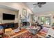 Cozy living room with a stone fireplace and ceiling fan at 6035 Bay Pond Rd, Ravenel, SC 29470