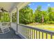 Relaxing covered porch showcasing a view of a pond and fountain at 6035 Bay Pond Rd, Ravenel, SC 29470