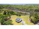 Aerial view of a property featuring lush greenery, a two-story home with a fire pit, and a serene marsh backdrop at 795 Shagule Rd, Edisto Island, SC 29438