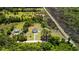 Expansive aerial view of a home with a long driveway, lush landscaping, and surrounding trees at 795 Shagule Rd, Edisto Island, SC 29438